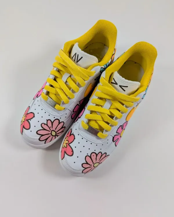 A front view of the "Air Flora1's," showing the bright floral pattern and sunny yellow laces. Perfect for summer.