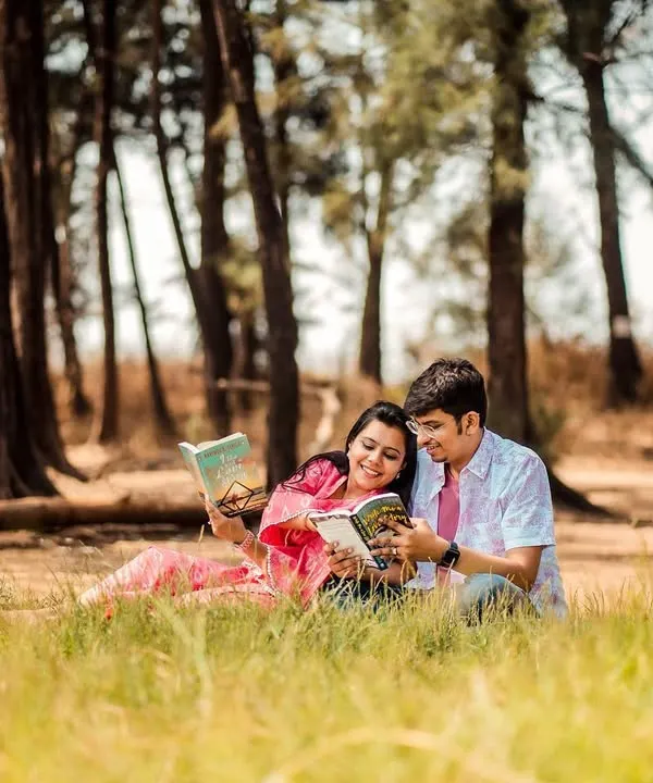 For the couple whose love story is written in books. A themed pre-wedding shoot in a forest clearing for two book lovers.