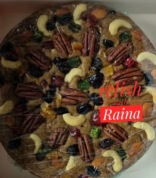 My classic Christmas fruit cake, packed and sealed for freshness. It's a dense, moist cake filled with rum-soaked fruits and a variety of crunchy nuts, perfect for festive celebrations.