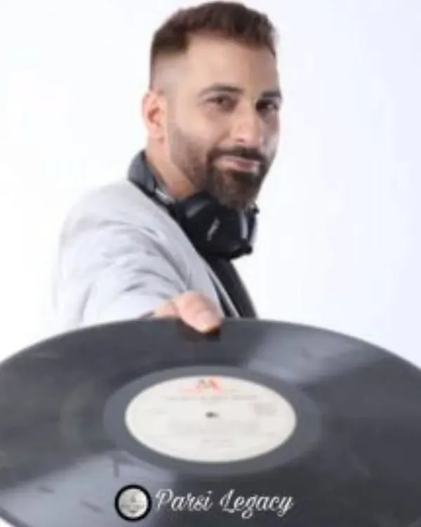 Holding a classic vinyl record. My love for music goes way back, from old-school records to today's digital beats. This deep appreciation for all genres of music is what allows me to be an open-format DJ who can cater to any crowd.