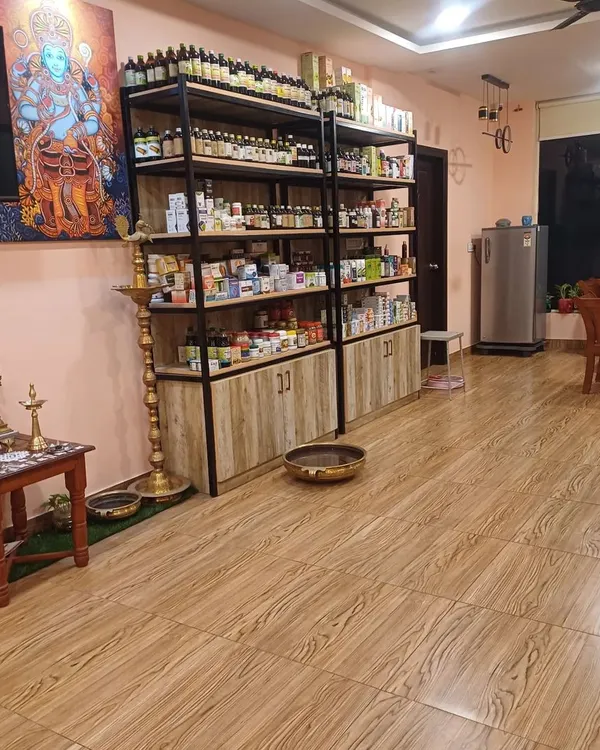 A view of our clinic's interior, showing the calm ambiance and our extensive in-house pharmacy. We stock a wide range of pure, authentic Ayurvedic herbal products to support your treatment plan.