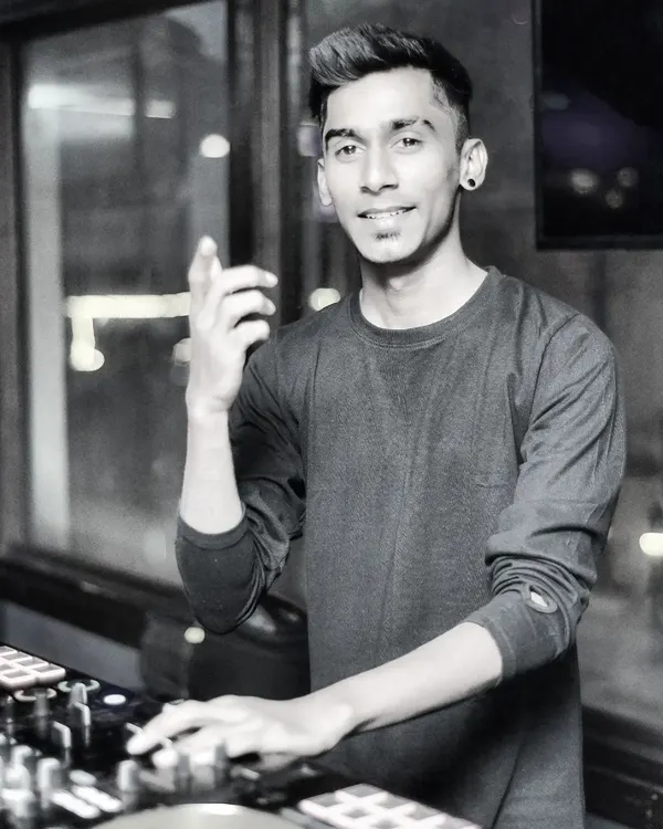 My purpose is simple: to lift your spirit and motivate you with music. A candid shot of me behind the decks, feeling the vibe.