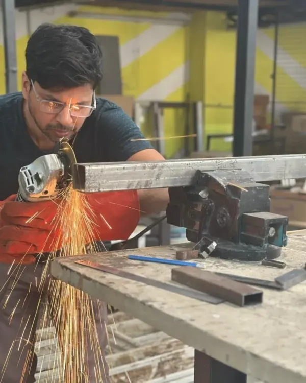 This is where ideas get real. Here, a member uses an angle grinder on a metal piece, sending sparks flying as they shape it for a custom furniture project. We provide all the safety gear and guidance you need to work with powerful tools like this.