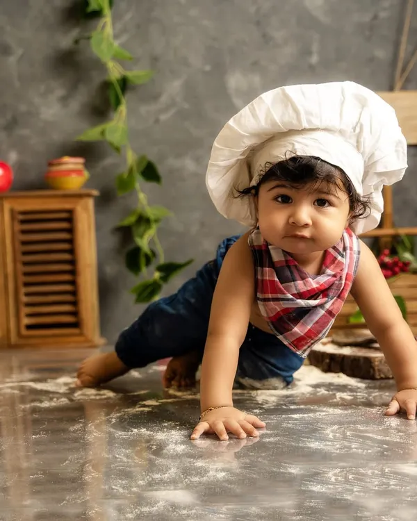 This little chef is on the move. A themed shoot is a great way to capture your baby's developmental milestones, like crawling, in a fun and creative way.