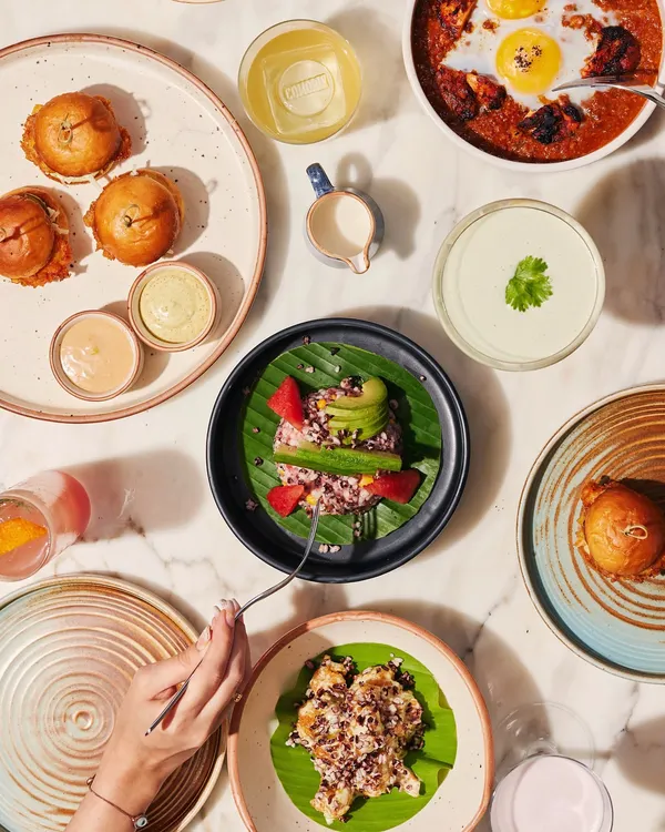 A bird's-eye view of a typical spread at Comorin. Our menu is designed for sharing, with a variety of small plates, mains, and sides that allow guests at any event to sample a wide range of flavors.