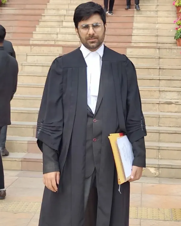 A formal portrait in my advocate's gown on the court steps. This uniform represents my progress and dedication to the legal profession.