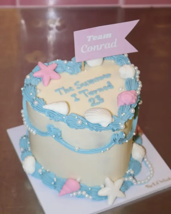 For the ones who never stopped rooting for Conrad. This "The Summer I Turned 23" cake is for you, complete with seashells, pearls, and a "Team Conrad" flag.