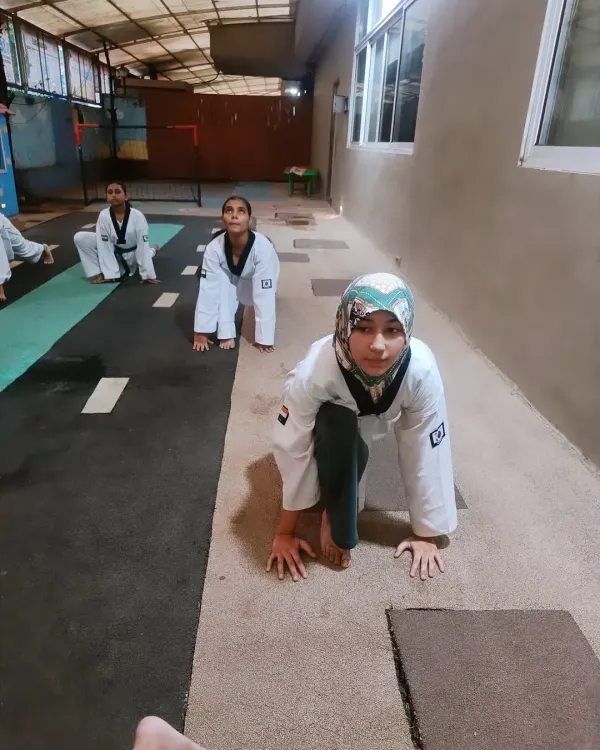 The warm-up is just as important as the training itself. Here, students get into a starting position for stretching, preparing their bodies for the intense workout ahead.