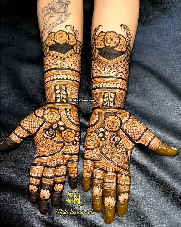 An Indo-floral fusion design that provides heavy coverage up to the forearms. The use of dark, filled sections makes the delicate floral patterns stand out beautifully.
