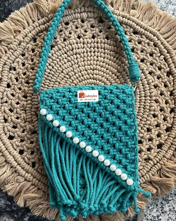 I love making these stylish accessories! This is my beautiful turquoise sling bag, handcrafted with a classic macrame knot pattern and finished with pretty pearl details. It’s the perfect size for your phone and essentials.