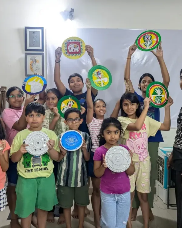 This is what pure joy looks like. A snapshot from one of my kids' workshops where everyone proudly shows off the unique papermache art they created from scratch.