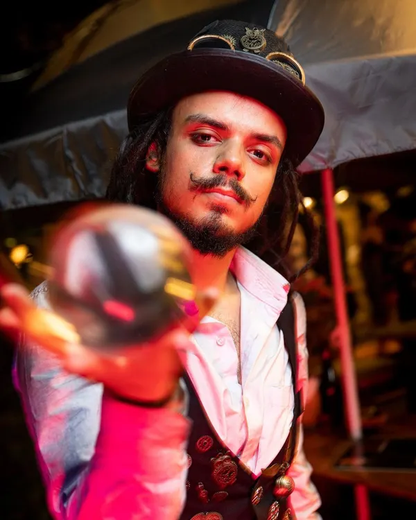 A portrait of our contact juggler in his Steampunk attire. He presents the crystal ball as if it were a magical artifact, adding to the illusion of the act.