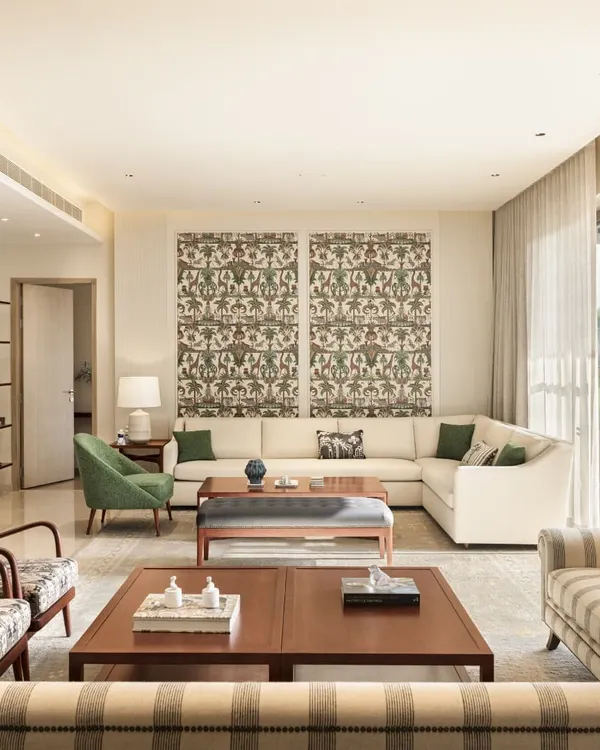 A living room from our Max128 project, where contemporary furniture is mixed with Indian-patterned fabrics. The open layout connects to the dining area and deck, creating a spacious and sociable environment.