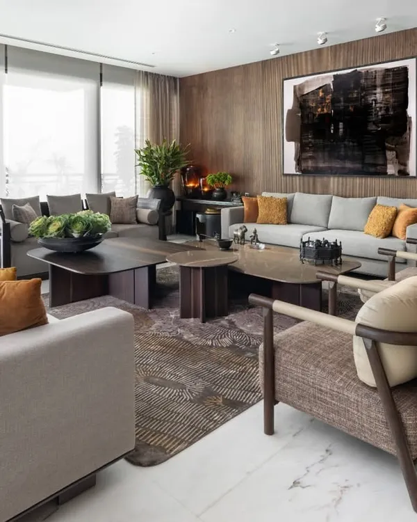 This living room is a story told in layers of light and texture. I designed this space to feel both expansive and intimate, using a custom ribbon veneer wall as a warm backdrop for curated art. The furniture, all from my Koko collection, balances soft contemporary lines with sculptural forms, creating a space that is not just for living, but for living beautifully.