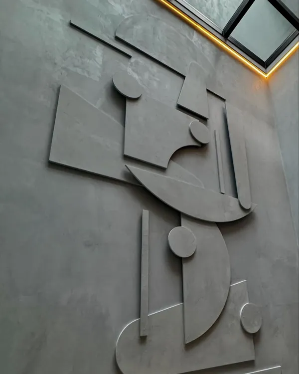 This abstract mural, crafted from microconcrete, serves as the central art piece in a West End home. The geometric shapes create a dynamic composition that interacts with the natural light from the skylight above. It’s a testament to how we use materials to create integrated art.