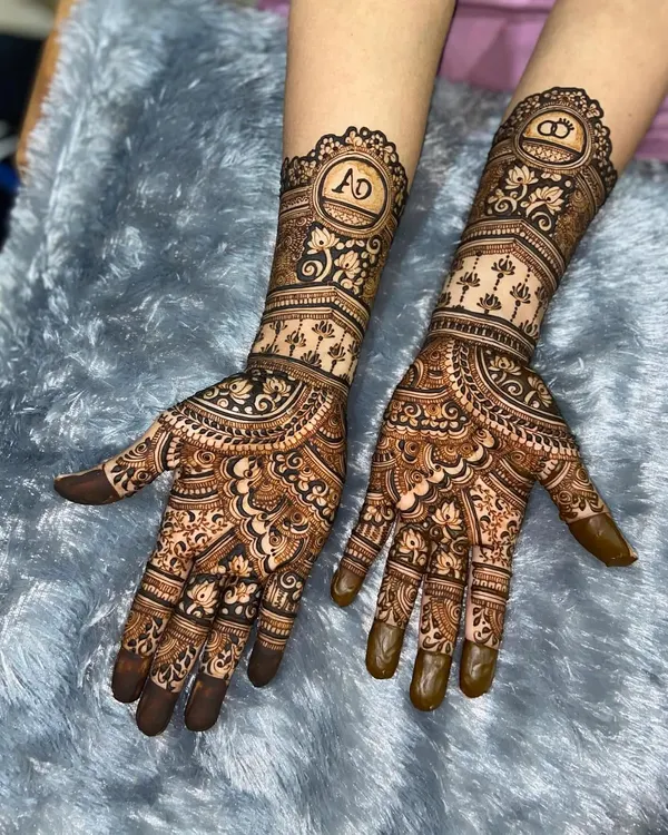 A perfect engagement mehendi with personalized initials 'A' and 'D' in beautiful circular frames. The design is a lovely mix of traditional patterns and modern personalization.