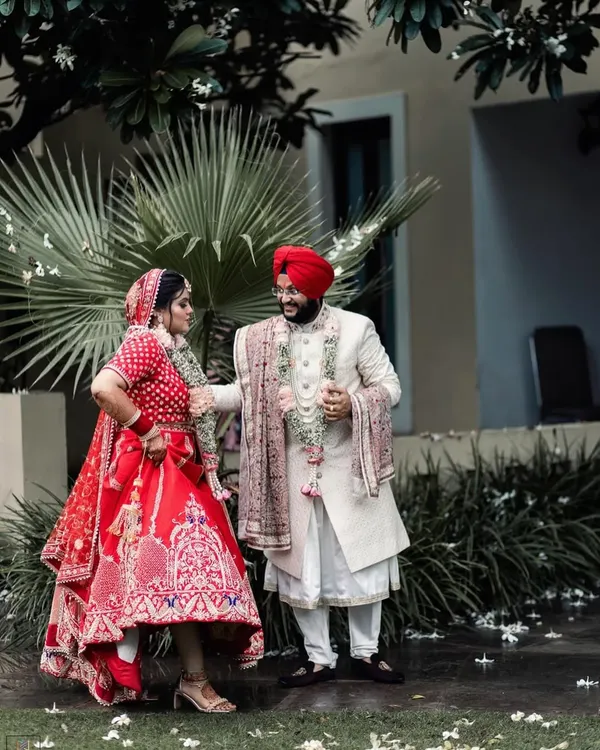 A fun and playful moment between the Sikh bride and groom. Her dynamic pose and his smiling reaction create a candid and joyful portrait that perfectly captures their personalities.