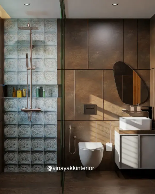 This bathroom design balances earthy and modern elements. The dark brown wall panels are complemented by a textured glass-block shower wall, a floating vanity, and an organically shaped mirror for a unique, high-end look.