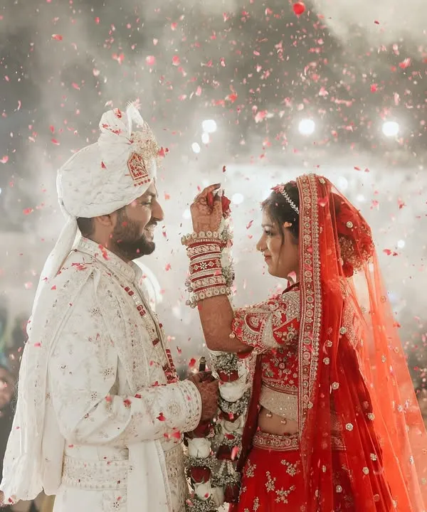 This is the moment. The one where the world fades away and all that's left is a shower of petals, the warmth of sparklers, and the beginning of forever. For me, capturing the Varmala is about freezing that electric energy, the shared glance, and the pure joy of two souls uniting. It’s the heart of the celebration, a memory painted in light and love.