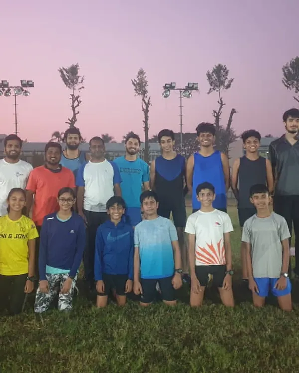 A group photo of our athletes and coaches after a tough evening session. This is our family, united by a shared goal of pushing our limits and supporting one another.