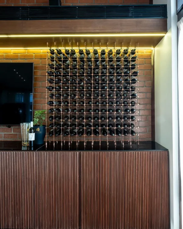 This is our 'Boutique de la Reserve', where you can purchase our wines. The design combines rustic brick cladding with a refined wooden ribbed counter and an exquisite wine display, creating a memorable shopping experience.