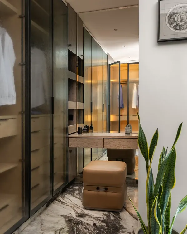 This is the ultimate walk-in wardrobe wonderland, nestled in a sprawling 4300 sq. ft. Mumbai paradise. I designed it with boutique-style shelving, ample mirrors, and a dedicated dressing table to make getting ready a true runway experience.