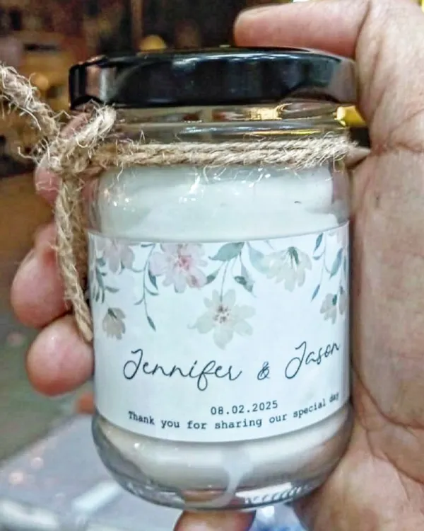 A close-up of a scented jar candle I made as a wedding favor. I can print your names, wedding date, and a thank you message on a custom label, making it a memorable return gift for your guests.