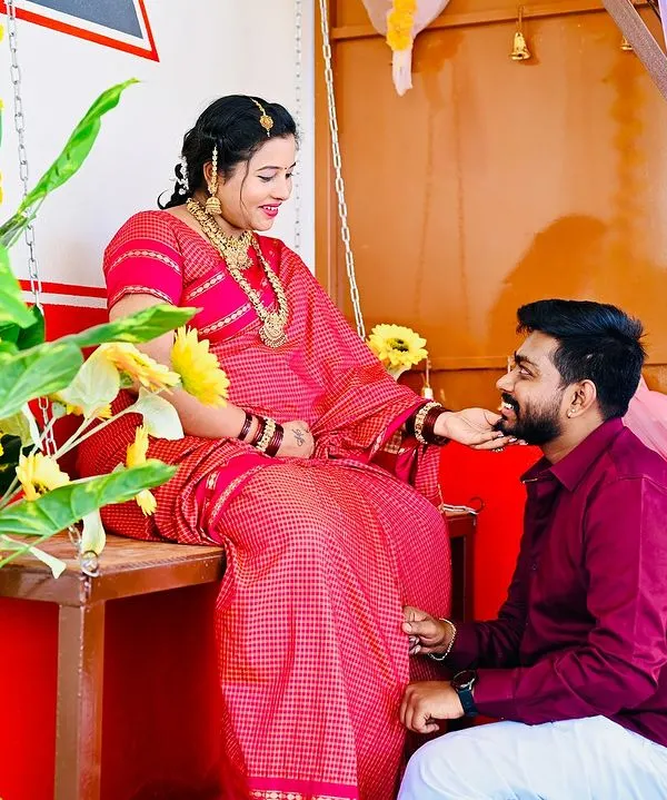 A beautiful moment of connection in my Halli Mane set. The vibrant colors of the traditional attire stand out against the red and white walls, creating a culturally rich maternity portrait.