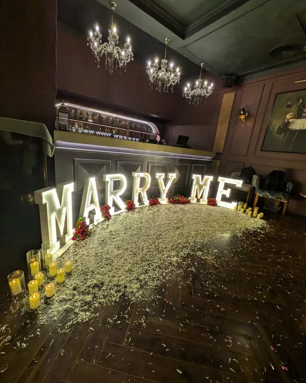 To make a proposal unforgettable, I use large, illuminated marquee letters. This 'MARRY ME' setup creates a dramatic and deeply romantic focal point in any venue, ensuring a picture perfect moment.