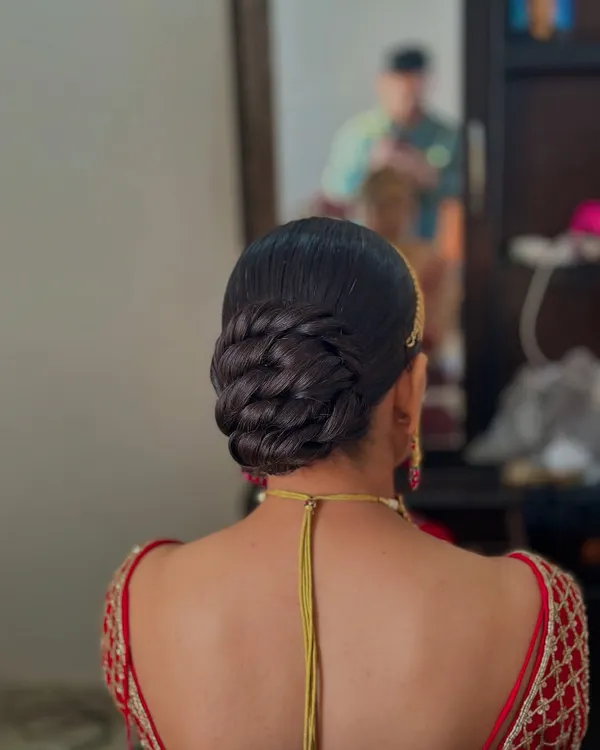 A perfectly clean and sleek twisted bun. This hairstyle is all about precision and elegance, offering a polished look for a bride who appreciates classic sophistication.