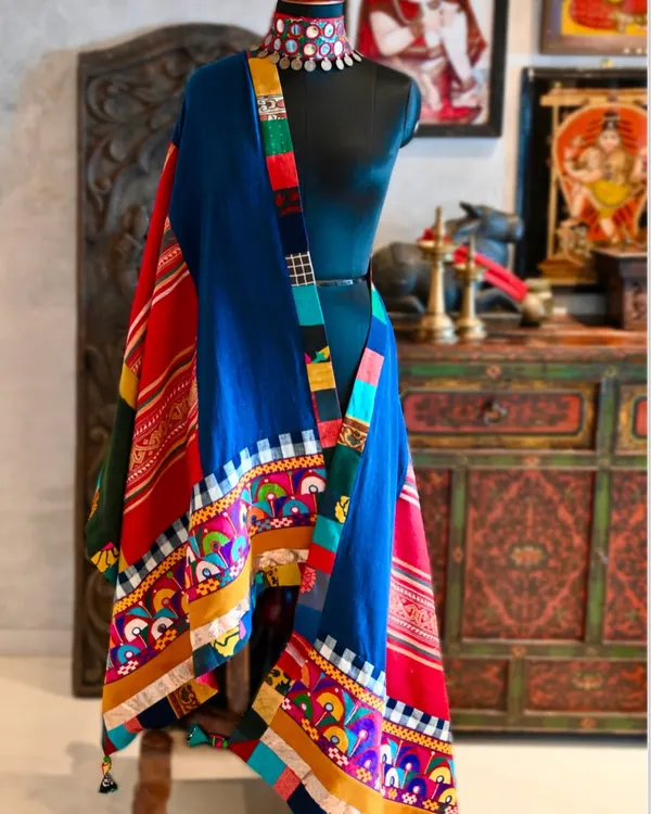 This chadar is a confluence of tribal weaves, blending hand-spun organic Kala cotton from Gujarat with vibrant Kutchi embroidery. It also incorporates a treasured hemp weave from Laos and Saput Poleng cotton from Bali.