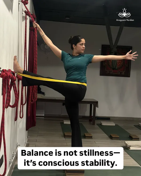 Balance is not stillness; it is conscious stability. Here, a student uses a wall rope to find alignment and stability in Utthita Hasta Padangusthasana (Extended Hand-to-Big-Toe Pose). The prop guides the body into clarity and awareness.
