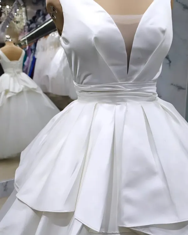 This modern satin bridal gown is one of my favorite creations. The deep V-neckline and structured, architectural peplum create a powerful and sophisticated silhouette for the contemporary bride.