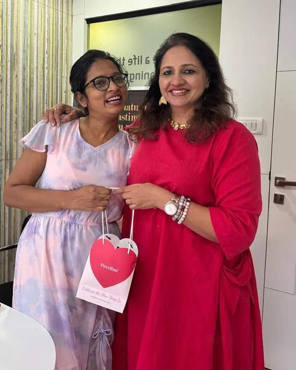 A happy moment in the clinic, personally handing over a Valentine's Day giveaway hamper to a wonderful client.