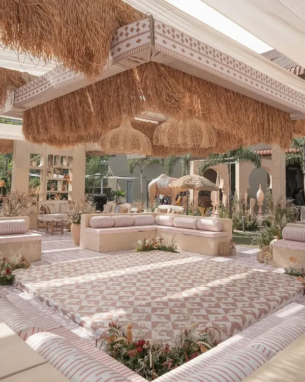 This is the 'Desert Oasis' theme I created for a Haldi ceremony. I designed a complete transformation of the space using low baithak-style seating, a custom-patterned floor, and a dramatic ceiling with thatched details and wicker lamps to create an immersive, rustic, and elegant atmosphere.