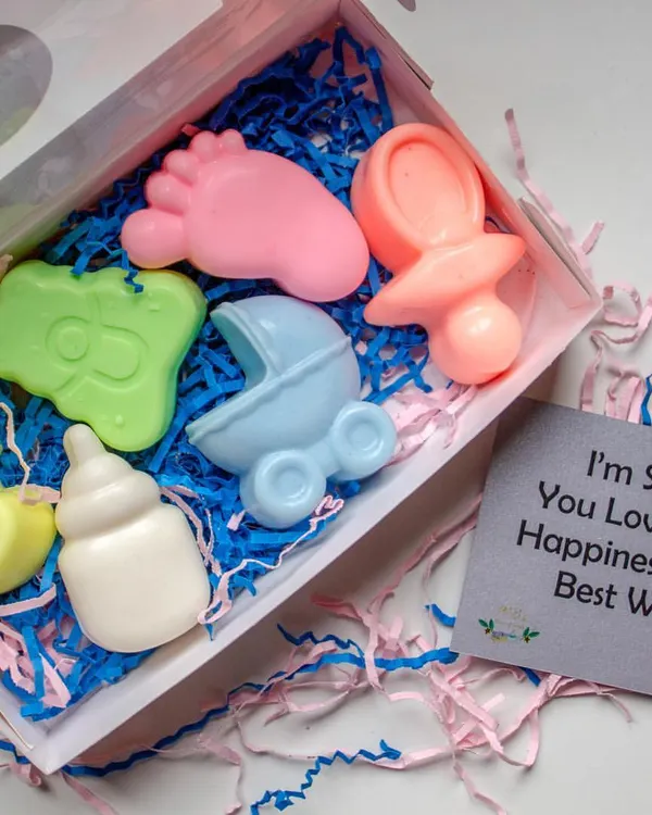 This baby shower themed soap set is a perfect return favor. It includes soaps shaped like a baby foot, rattle, pacifier, and stroller, all handcrafted with shea butter and essential oils to be completely safe for delicate skin.