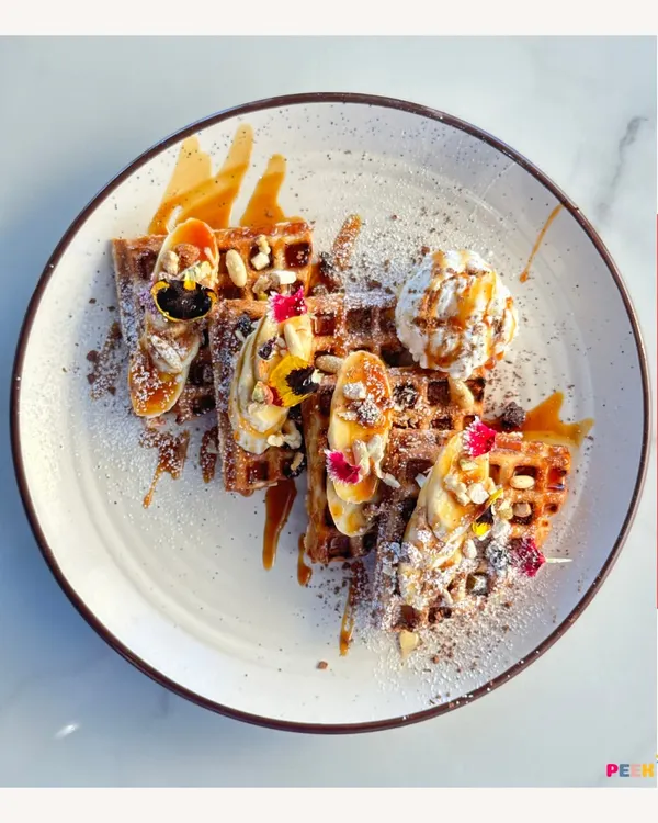 Feast your eyes on these gorgeous waffles, loaded with bananas, nuts, and a caramel drizzle. A perfect treat after a session of play.