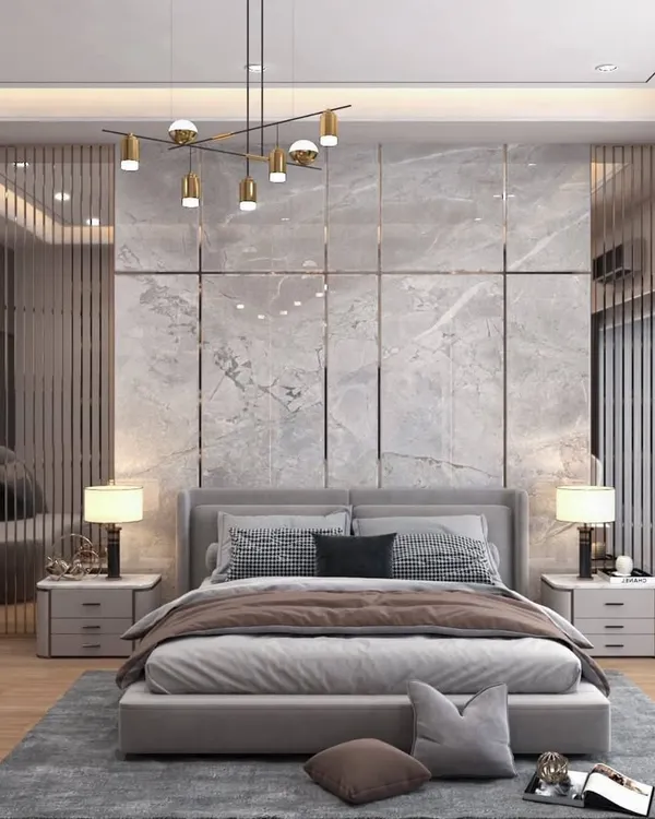 This master bedroom is a sanctuary of luxury and calm. We used a statement marble-finish wall with metallic inlays, complemented by bespoke bedside tables and sophisticated pendant lighting to create an atmosphere of modern elegance.