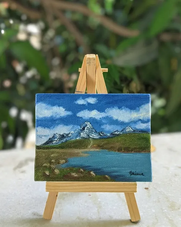 Here is the Chandrataal Lake painting resting on its mini easel. It shows how these tiny artworks can sit on your desk or a shelf, bringing a view of the Himalayas right into your room.