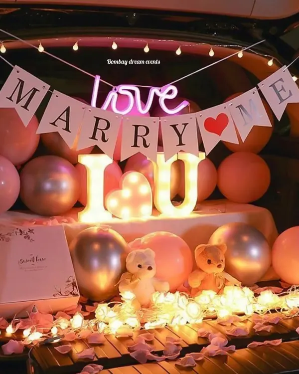 A romantic "Marry Me" car trunk proposal setup. This design uses marquee letters spelling "I ❤️ U", a "Marry Me" banner, a "love" neon sign, and soft lighting for a truly memorable surprise.