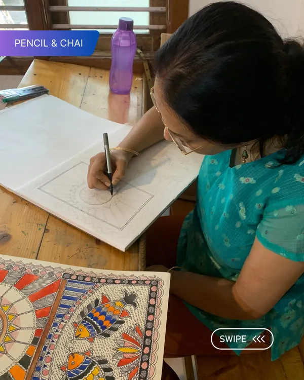 A student is deeply focused on the precise line work of her Madhubani drawing. Our studio provides the quiet intensity needed for such detailed work.