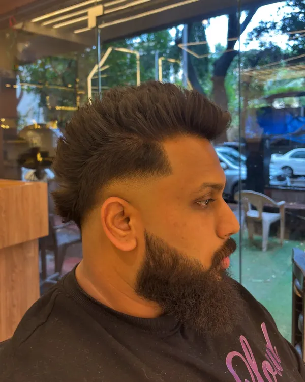 A modern men's haircut featuring a sharp fade and a styled mullet. This look is all about texture and confidence.