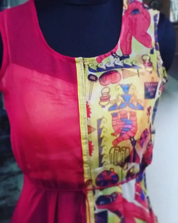I love to experiment with fusion designs. This dress combines a solid pink georgette with a quirky, colorful printed fabric, creating a playful and modern Indo-Western piece that is truly unique.