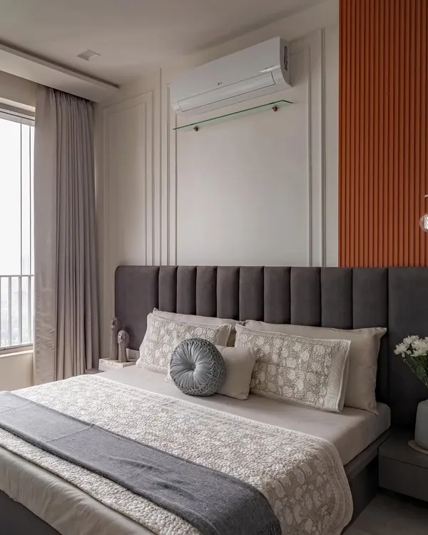 A master bedroom that makes a statement. We used color blocking with charcoal grey and a burnt orange fluted panel to create a look that is both bold and balanced, energetic and sophisticated.