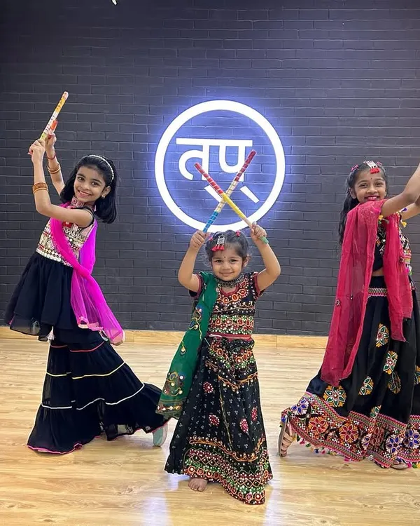 The vibrant energy of our kids' Garba class. Dressed in traditional attire and holding dandiya sticks, they are all set for a Navratri celebration.