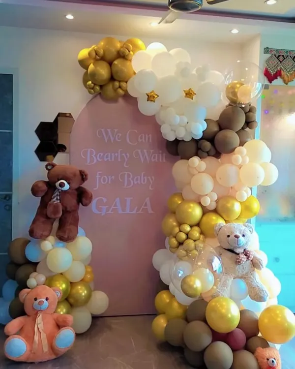 Our "We Can Bearly Wait" theme is a client favorite for baby showers. This setup features a custom arched backdrop, an organic balloon garland, and multiple teddy bears, creating a sweet and memorable scene.