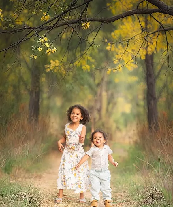 We didn't just pick a location; we chose a moment. This path in the woods was the perfect setting to capture the story of these siblings running toward their next adventure.