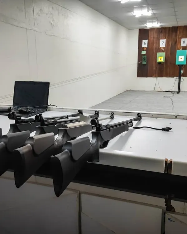 A view of the shooting lane counters with air rifles ready for a session. The range is equipped with modern target systems and analysis tools.