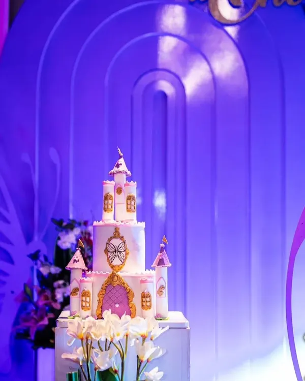 A beautiful castle cake that is every little girl's dream. This photo shows the cake at the event, where the purple lighting made it look even more magical.