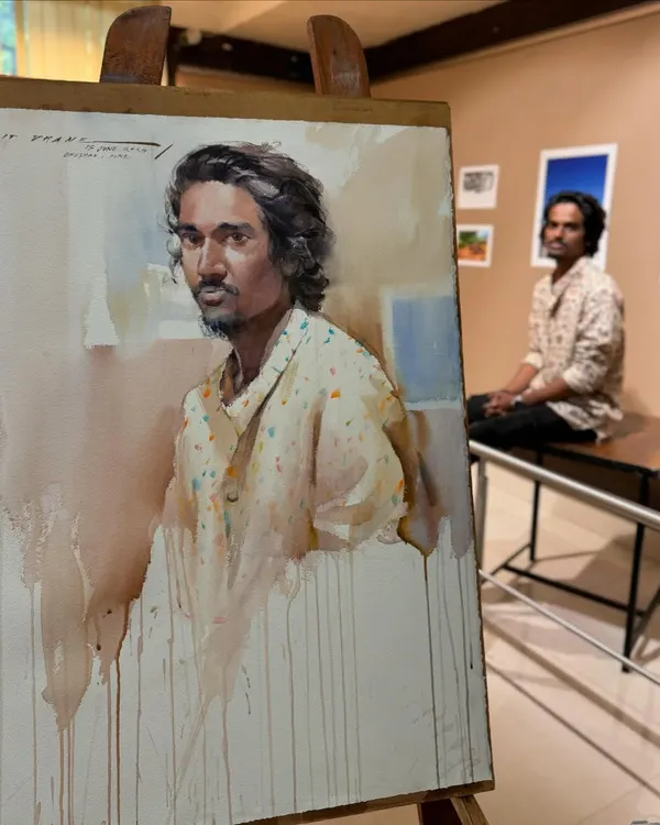 The finished watercolour portrait next to the model at the Kalangan Art Exhibition at Balgandharva Kaladalan, Pune. My goal is always to capture the subject's unique presence.